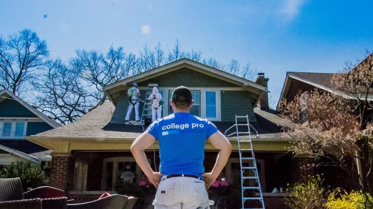 a man standing on the roof of a house